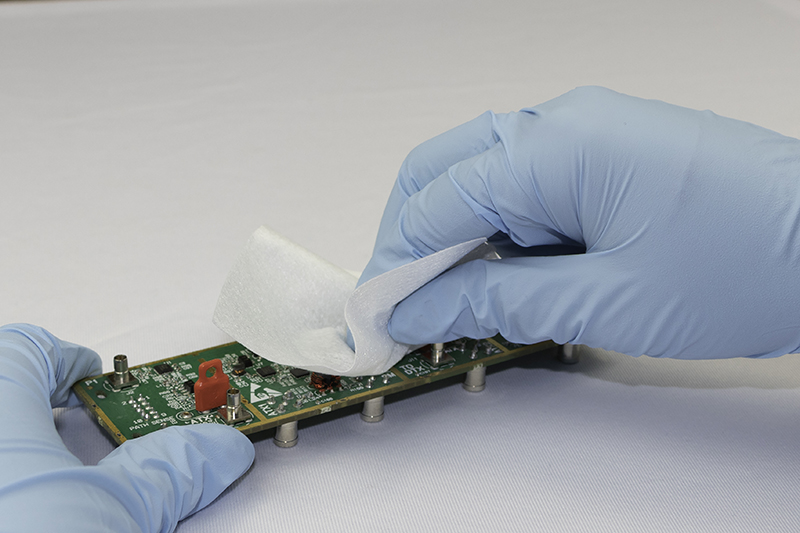 Left: Circuit Board with Wipe - It is  essential to match the type of wipe absorbency to the contamination to be removed